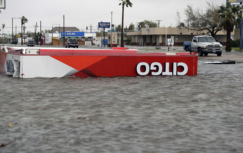 
              The roof of a gas station sits in flood waters in the wake of Hurricane Harvey, Saturday, Aug. 26, 2017, in Aransas Pass, Texas.   Harvey rolled over the Texas Gulf Coast on Saturday, smashing homes and businesses and lashing the shore with wind and rain so intense that drivers were forced off the road because they could not see in front of them.  (AP Photo/Eric Gay)
            