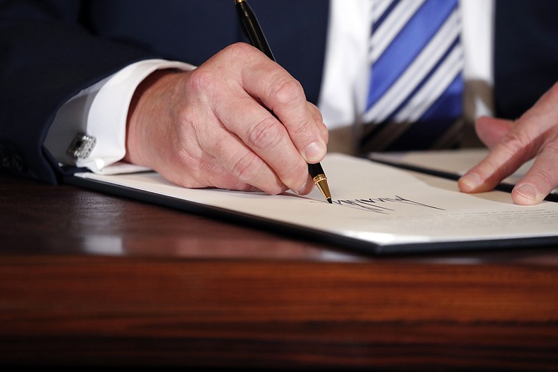 In this July file photo, U.S. President Donald Trump signs a proclamation. (AP Photo/Alex Brandon, File)