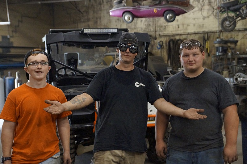 Garage Bound owner Michael Brandt, middle, stands in his studio with two of the local teens he mentors, Ethan Cavanaugh, left, and Austin Waldo. (Staff photo by Myron Madden)