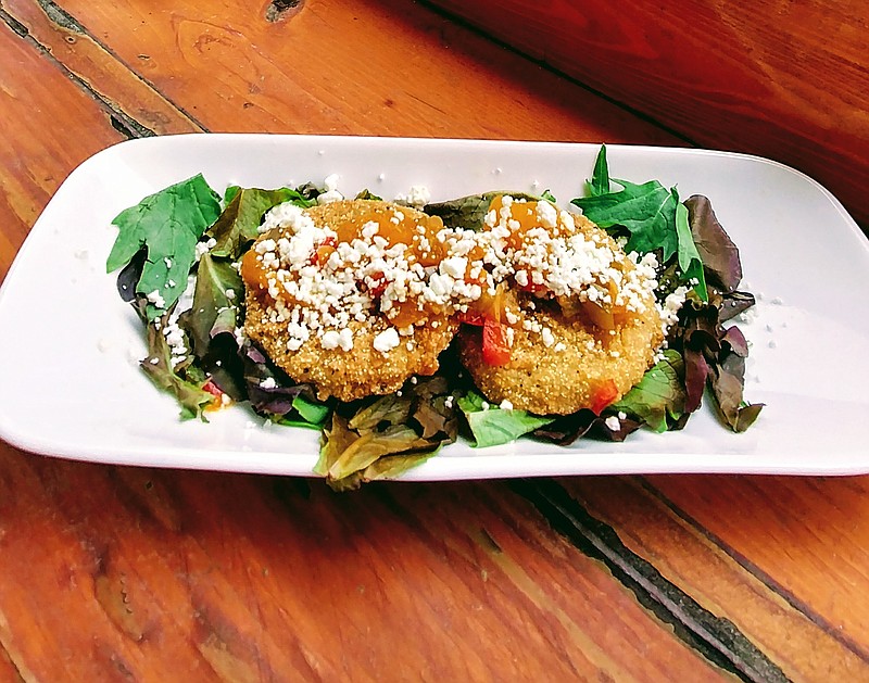 Fried green tomatoes at The Crimson Moon are topped with mango-peach salsa and cheese.