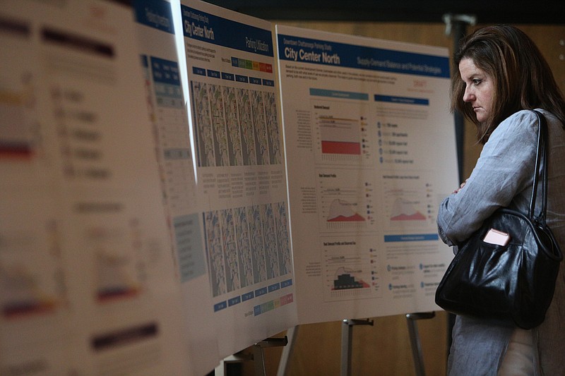 Lisa Brown, a commercial realtor with Keller Williams Realty, looks at maps of parking utilization of what was specified as "City Center North" from a parking study of downtown Chattanooga held Monday, Aug. 28, 2017, at the Bessie Smith Cultural Center in Chattanooga, Tenn. Brown is both a commercial realtor and owns property along M.L. King Boulevard.