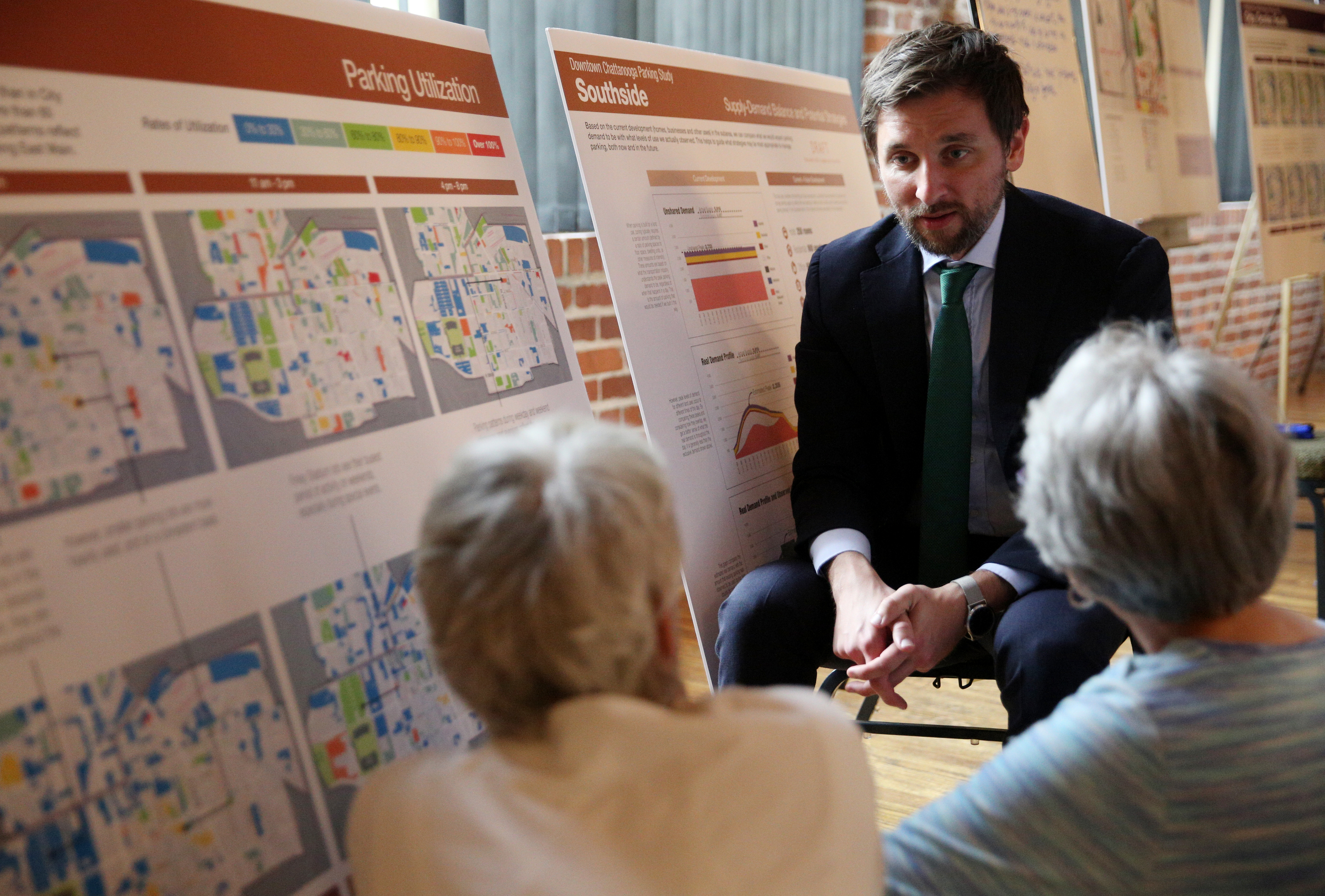 Joel Mann, a senior associate with Nelson/Nygaard Consulting Associates, gets feedback from Colleen Carboni and Tresa McCallie about their concerns with downtown parking Monday, Aug. 28, 2017, at the Bessie Smith Cultural Center in Chattanooga, Tenn. Carboni owns a Pilates studio in the downtown area and was interested in the possibility of renting parking for her customers to reduce "parking anxiety," while McCallie expressed her concern for having to ask house guests to park two or three blocks away.