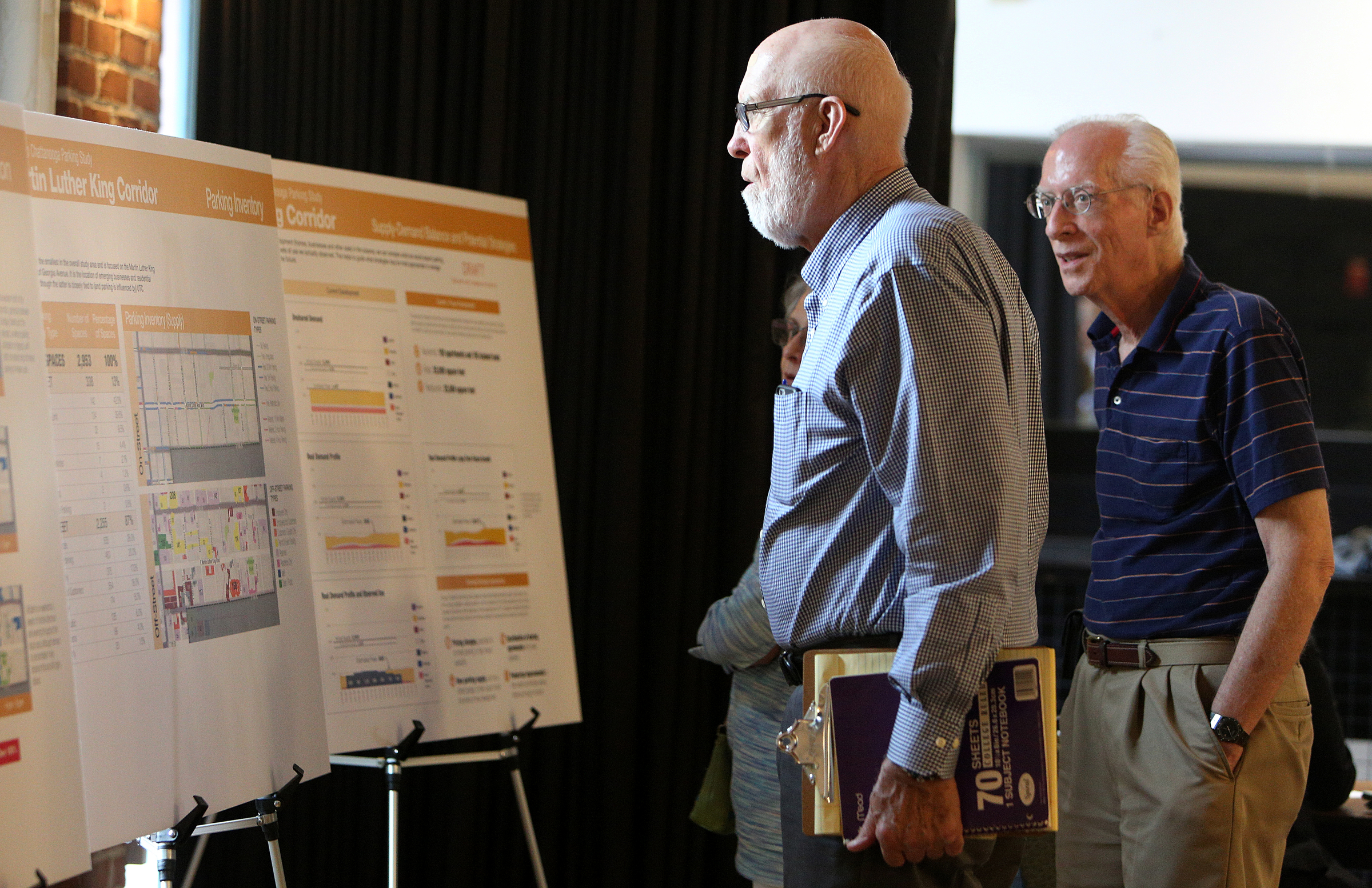 Franklin McCallie and Martin Hershey check out maps and diagrams from a parking study performed on the downtown Chattanooga area Monday, Aug. 28, 2017, at the Bessie Smith Cultural Center in Chattanooga, Tenn. Community members were able to get a look at a parking study performed by Nelson/Nygaard Consulting Associates and give their own feedback.