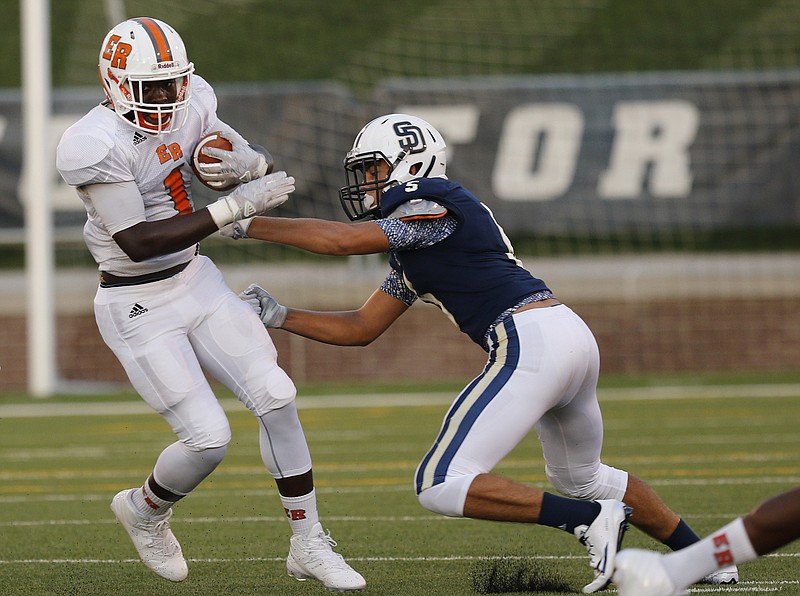 East Ridge's Lorenzo Stewart, left, breaks around Soddy-Daisy's Zach Johnson during their football game in the prep football jamboree at Finley Stadium on Saturday, Aug. 13, 2016, in Chattanooga, Tenn.