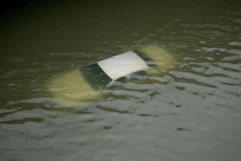 A car is submerged on a freeway flooded by Tropical Storm Harvey on Sunday, Aug. 27, 2017, near downtown Houston, Texas. The remnants of Hurricane Harvey sent devastating floods pouring into Houston on Sunday as rising water chased thousands of people to rooftops or higher ground. (AP Photo/Charlie Riedel)

