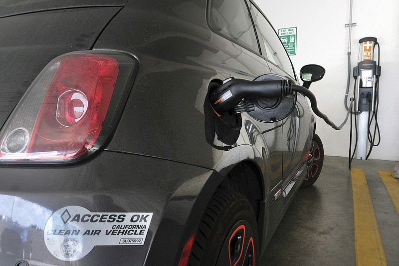 
              This April 25, 2016, photo shows an electric Fiat plugged into a charging station in a parking lot in Los Angeles. California could spend up to $3 billion under a bill that would widely expand its consumer rebate program for zero-emission vehicles. The Legislature is pushing forward a bill that could lift rebates from $2,500 to $10,000 or more for a compact electric car. Current rebates have done little to boost sales. (AP Photo/Richard Vogel)
            