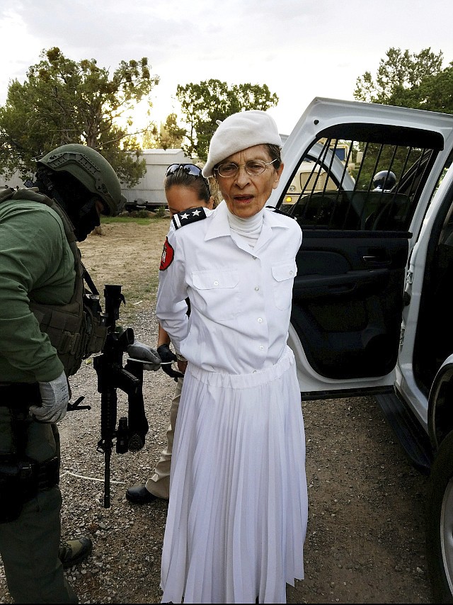 
              In this Aug. 20, 2017 photo provided by the Cibola County Sheriff's Office, Deborah Green, leader of the paramilitary Christian sect Aggressive Christianity Missions Training Corps, is arrested outside of the group's secluded Fence Lake, N.M., compound after Cibola County deputies raided the grounds. Green and seven members of the group are facing charges in connection with a child abuse and child sexual abuse investigation in New Mexico. (Cibola County Sheriff's Office via AP)
            