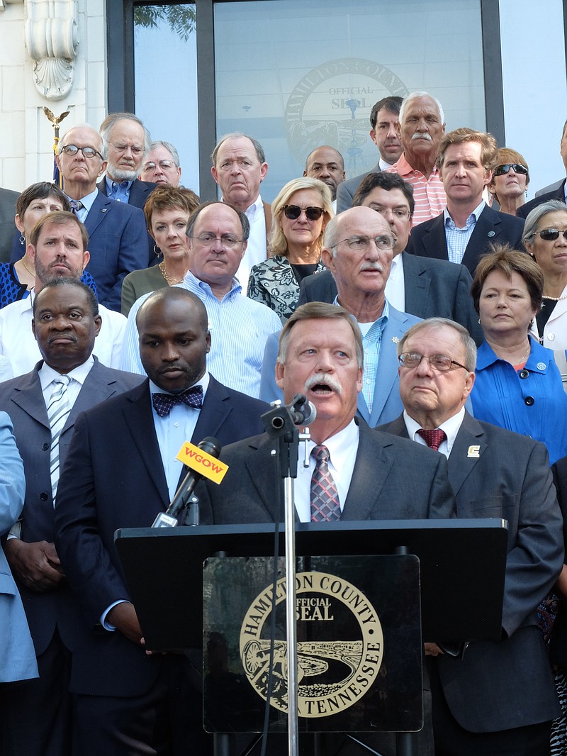 Backed by government officials, employees and supporters, Hamilton County Mayor Jim Coppinger announces new projects for the county Tuesday morning on the steps of the Hamilton County Courthouse.