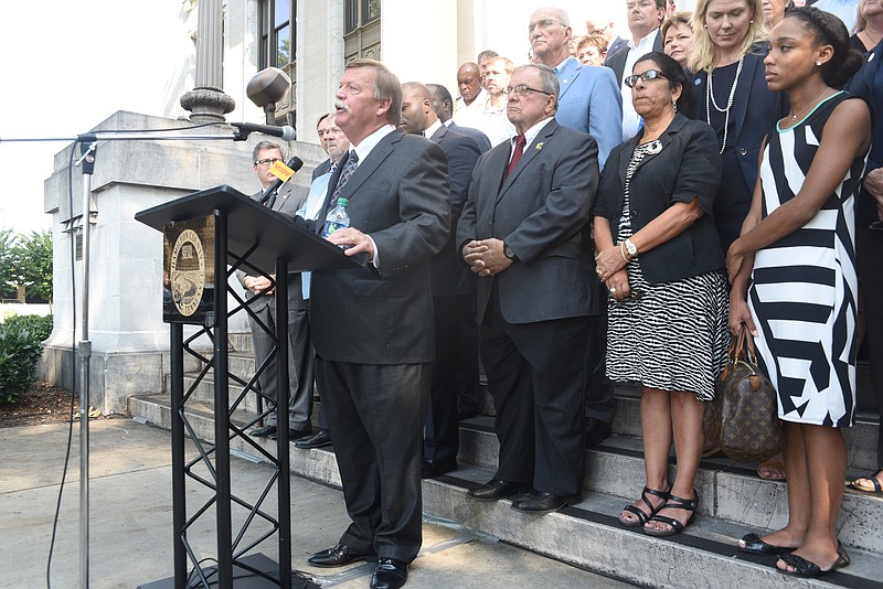 Backed by government officials, employees and supporters, Hamilton County Mayor Jim Coppinger announces new projects for the county on the morning of Tuesday, August 29, 2017 on the steps of the Hamilton County Courthouse.