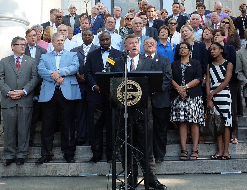Staff photo by Tim Barber Hamilton County Mayor Jim Coppinger announces new projects for the county that will mean a tax increase Tuesday morning on the steps of the Hamilton County Courthouse.