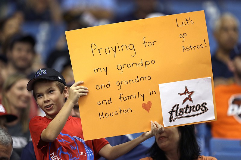 
              A young fan holds up a sign during the first inning of a baseball game between the Houston Astros and the Texas Rangers Tuesday, Aug. 29, 2017, in St. Petersburg, Fla. The Astros moved their three-game home series against the Rangers to St. Petersburg because of unsafe conditions from Hurricane Harvey. (AP Photo/Chris O'Meara)
            