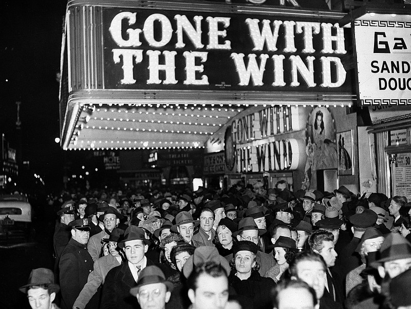 In this Dec. 19, 1939, file photo, a crowd walks past the Astor Theater during the Broadway premiere of "Gone With the Wind" in New York. A Memphis, Tennessee, theater has cancelled an annual screening of the classic 1939 film because of racially insensitive content. (AP Photo, File)