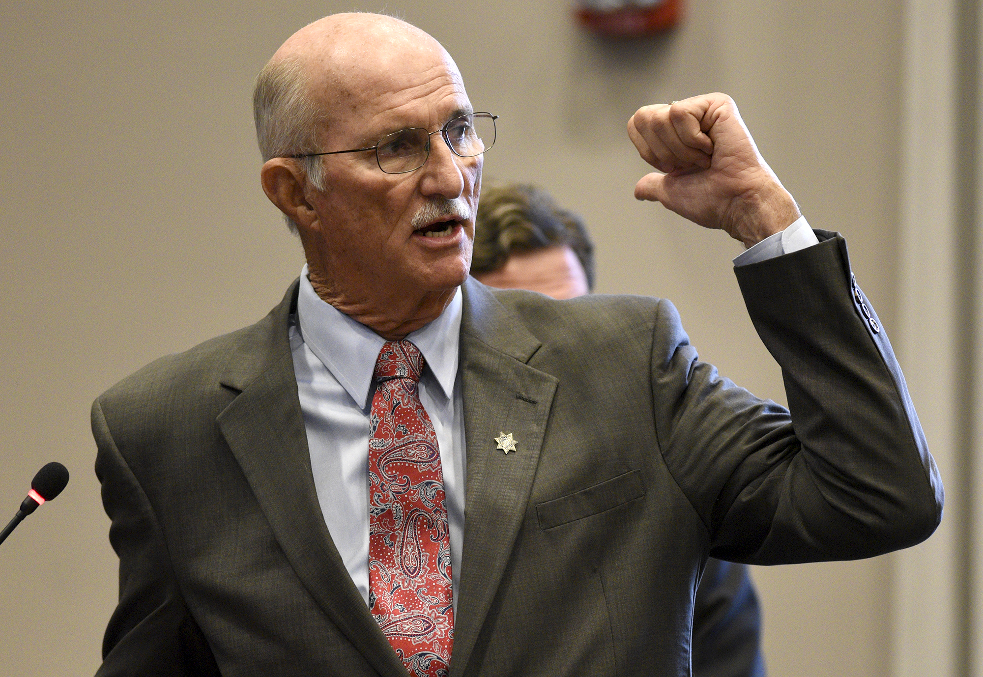 Hamilton County Sheriff Jim Hammond answers questions from the commission. Listening in the background is Tom Morsch Managing Director of PFM Financial Advisors LLC. The Hamilton County Commission listened to a presentation and recommendations for short and long-term jail and workhouse overcrowding at the Wednesday meeting in the Hamilton County Courthouse on August 29, 2017.