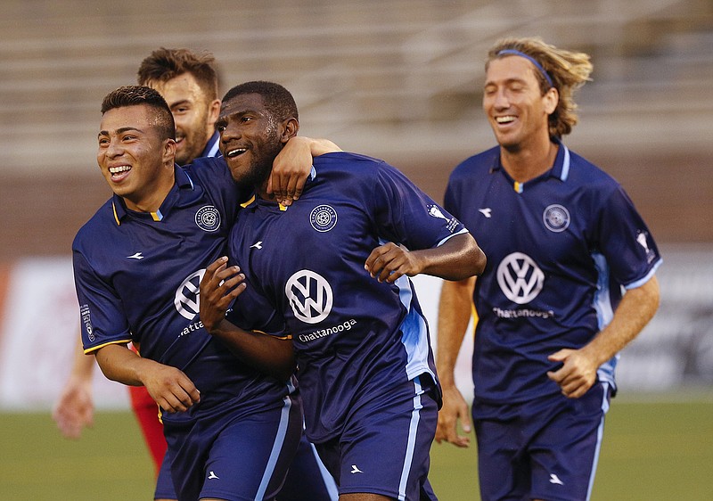 Chattanooga FC's David Perez, left, and Juan Hernandez, right, congratulate teammate Felipe Antonio, center, after a goal during a match against Birmingham in May at Finley Stadium.