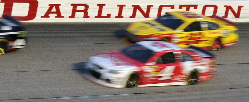 Kevin Harvick, front, and Joey Logano compete in a NASCAR Cup Series race at Darlington Raceway in April 2014. The South Carolina track will host the Bojangles' Southern 500 on Sunday night.