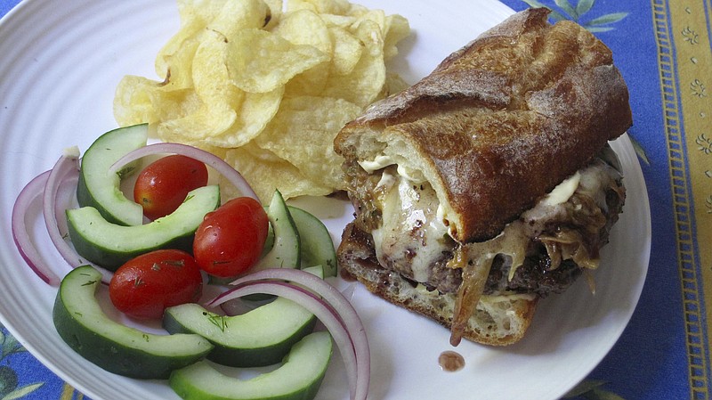 This Aug. 23, 2017 photo shows a French onion soup burger in New York. This dish is from a recipe by Sara Moulton. (Sara Moulton via AP)