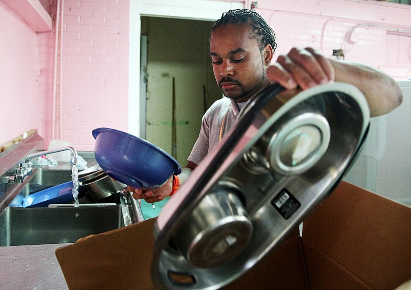 Darius Cox, an animal caretaker, washes bowls donated to the Humane Educational Society in Chattanooga, Tenn., on Thursday, Aug. 31, 2017. Blankets, bowls and food were donated to the Humane Educational Society by many who wanted to contribute to sheltering animals displaced by flooding in Houston. 