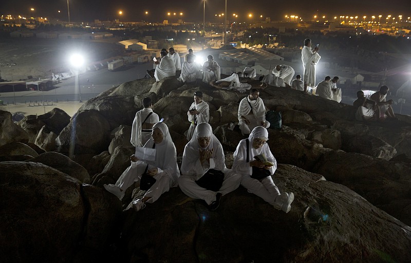 
              Muslim pilgrims pray on top of the Jabal Al Rahma holy mountain, or the mountain of forgiveness, upon their arrival to Arafat for the annual hajj pilgrimage, outside the holy city of Mecca, Saudi Arabia, Wednesday, Aug. 30, 2017. (AP Photo/Khalil Hamra)
            