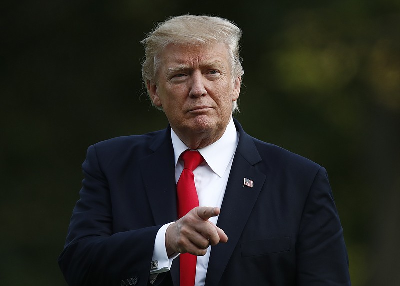 President Donald Trump points as he walks from Marine One across the South Lawn to the White House in Washington, Wednesday, Aug. 30, 2017, as he returns from Springfield, Mo. (AP Photo/Carolyn Kaster)