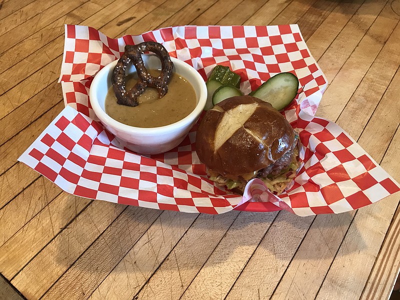 Beer cheese soup is a great companion for brat sliders with slaw on a pretzel roll.