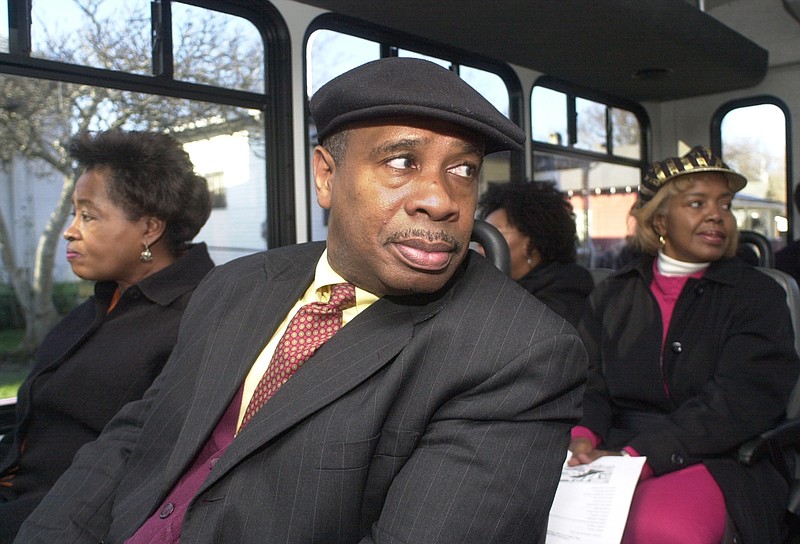 Al Chapman, center, then-executive director of Inner-City Ministries, rides a bus with others in 1999 during a tour of high crime areas in East Chattanooga.