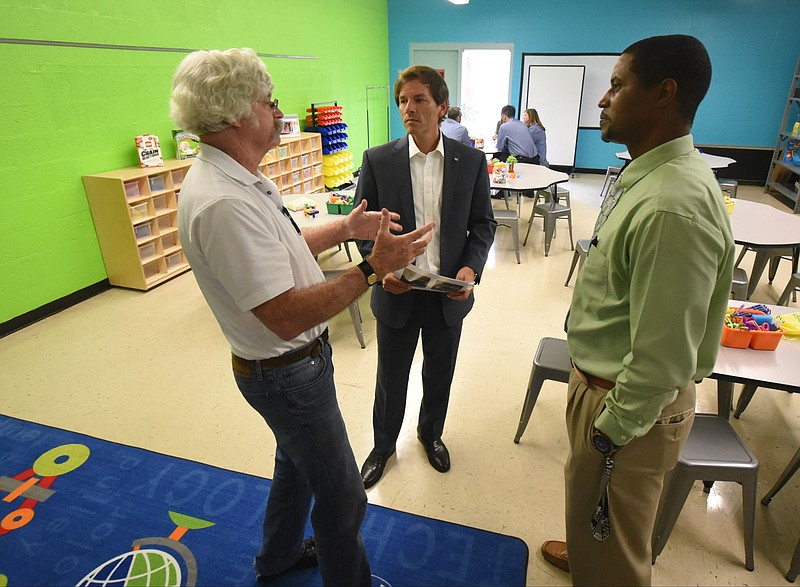 Charley Spencer, left, TVA Progam Manager for Communication, talks with Scott Self, center, TVA IT Chief Information Officer, and Talley Caldwell, Woodmore assistant principal in the newly constructed STEAM learning room at  Woodmore Elementary School.

