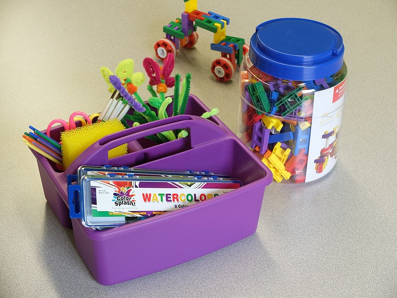 A plastic caddy of art supplies are at the center of each work table for pre-K through fifth graders work inside the new TVA STEAM learning room at Woodmore Elementary.  