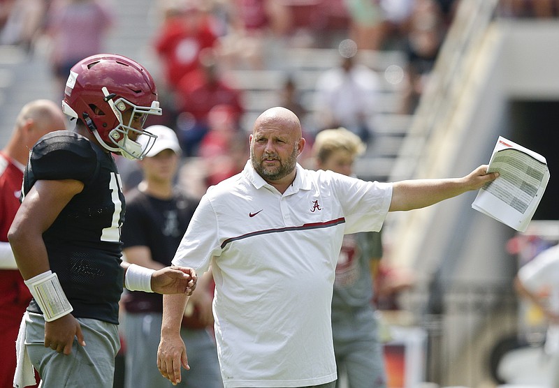 FILE - In this Aug. 5, 2017, file photo, Alabama offensive coordinator Brian Daboll, right, gestures while speaking to quarterback Jalen Hurts during an NCAA college football practice at Bryant–Denny Stadium, in Tuscaloosa, Ala. Alabama and the Southeastern Conference are trying to climb back atop the college football mountain. The SEC was toppled at least temporarily from that summit by the Atlantic Coast Conference last season.(AP Photo/Brynn Anderson, File)