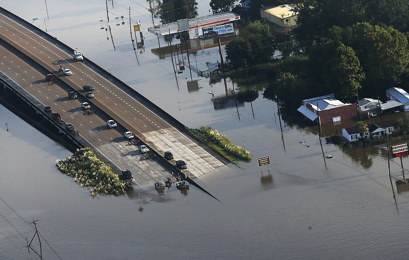 
              People launch boats from an overpass into floodwaters in the aftermath of Tropical Storm Harvey in Kountze, Texas, Thursday, Aug. 31, 2017. (AP Photo/Gerald Herbert)
            