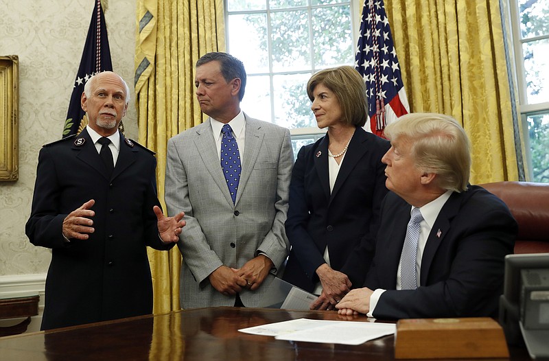 
              President Donald Trump addresses Commissioner David Hudson, National Commander, Salvation Army USA, left, Kevin Ezell, President of Southern Baptist Disaster Relief, American Red Cross CEO Gail McGovern, in the Oval Office of the White House, Friday, Sept. 1, 2017, in Washington. (AP Photo/Alex Brandon)
            