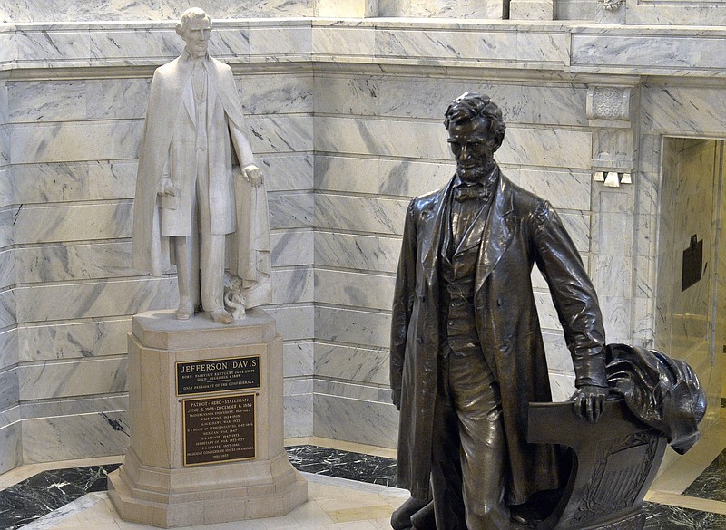 
              FILE - In this Wednesday, Aug. 5, 2015 file photo, a statue of Jefferson Davis, left, looks towards a statue of Abraham Lincoln in the Rotunda of the Kentucky State Capitol in Frankfort, Ky. Did 620,000 die, as Northerners would have it, in a noble quest to save the union and end slavery _ the nation’s horrific original sin? Or was the “War Between the States” a gallant crusade to limit federal power, with slavery playing a lesser part, as Southerners insisted? (AP Photo/Timothy D. Easley)
            
