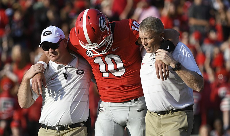 Georgia quarterback Jacob Eason (10) is helped off the field after an injury during the first quarter of an NCAA college football game against Appalachian State, Saturday, Sept. 2, 2017, in Athens, Ga. (AP Photo/John Amis)
