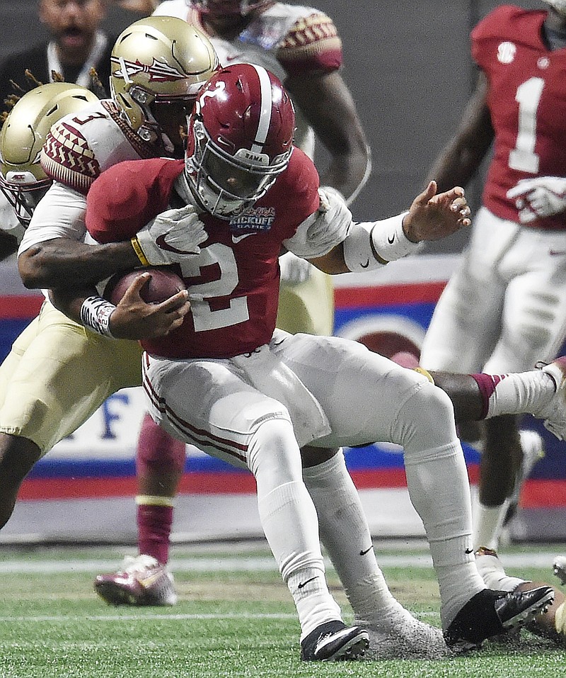 Florida State defensive back Derwin James (3) tackles Alabama quarterback Jalen Hurts (2) behind the line of scrimmage during the second half of an NCAA football game, Saturday, Sept. 2, 2017, in Atlanta. (AP Photo/Mike Stewart)