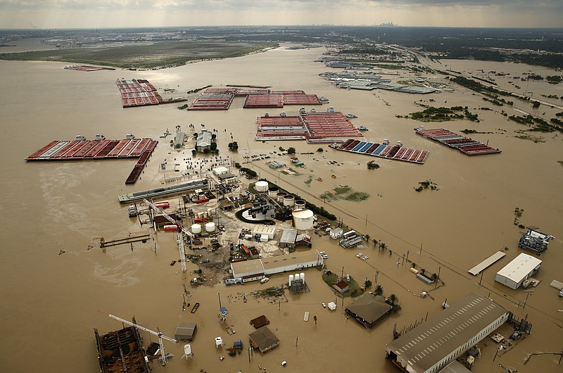 
              In this Aug. 30, 2017, photo, barges are secured by tugboats in the flood-swollen Burnet Bay along the Houston Ship Channel in Houston. (Tom Fox/The Dallas Morning News via AP)
            