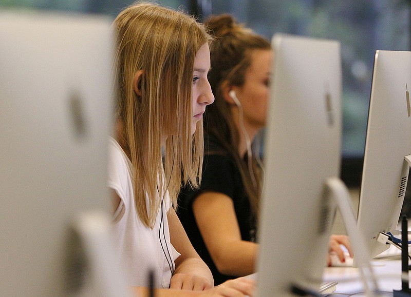 Claire Fox, 13, follows instructions on a worksheet as she learns how to use Adobe Illustrator Friday, Sept. 1, 2017, at the Gordon County College and Career Academy in Calhoun, Ga. Students can take classes in graphic design, marketing, information technology as well as engineering, drafting and design through the career academy. 