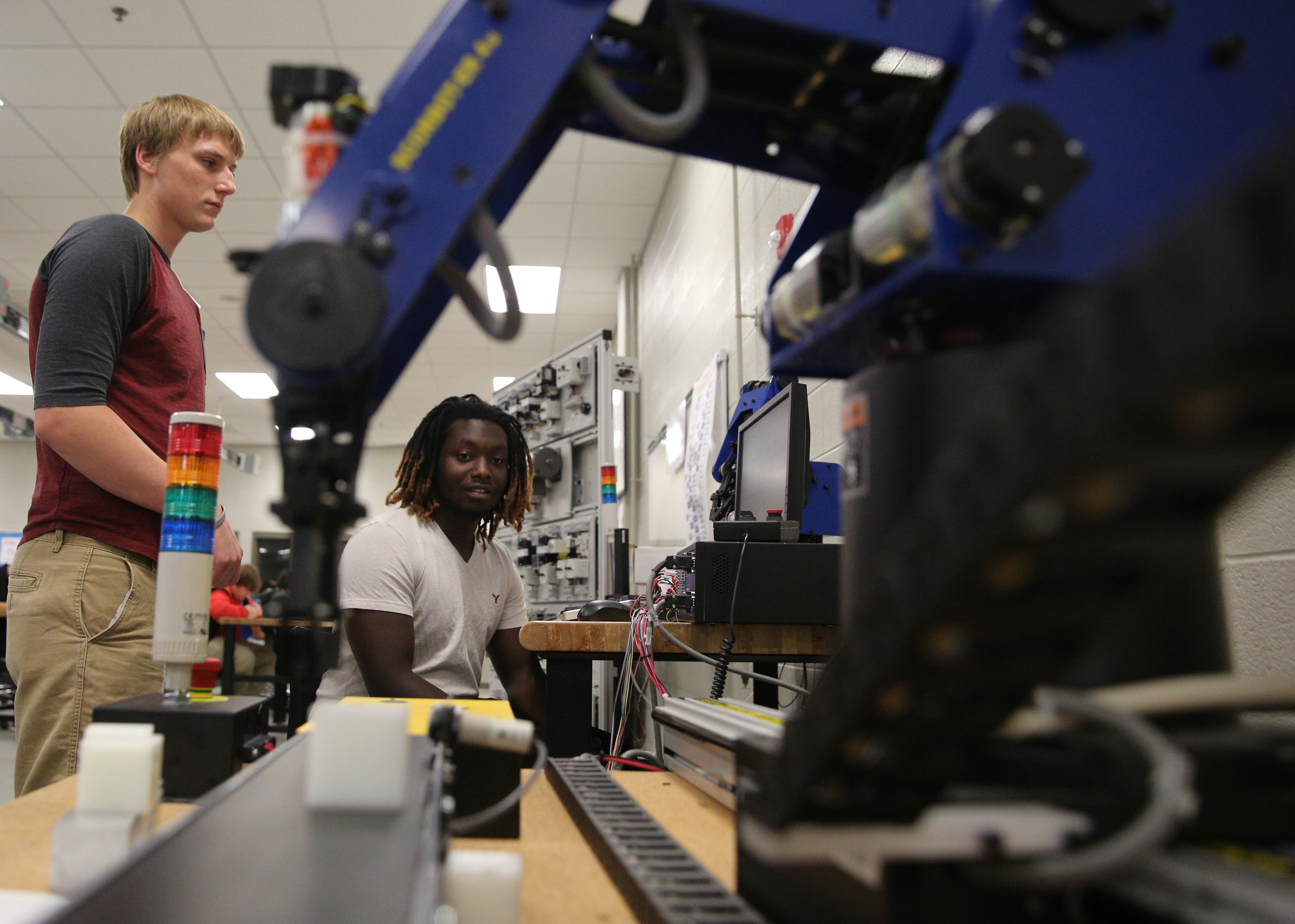 Tully Holden, 17, and Martavius Harris, 18, work on programming a robot to play checkers Friday, Sept. 1, 2017, at the Gordon County College and Career Academy in Calhoun, Ga. The career academy aims to prepare students to be both college and career ready.