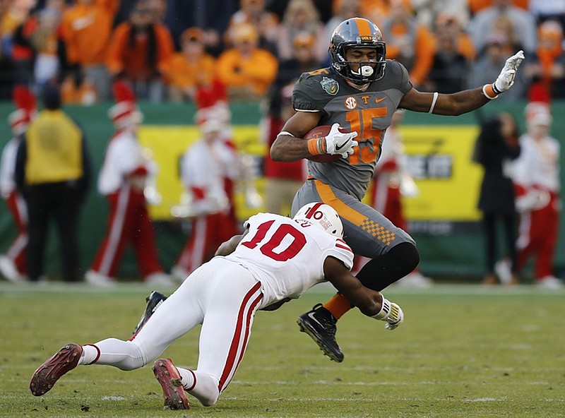 Tennessee wide receiver Jauan Jennings jumps a tackle attempt by Nebraska's Joshua Kalu during the Music City Bowl last December. The Vols start a new season tonight when they take on Georgia Tech at Mercedes-Benz Stadium in Atlanta.