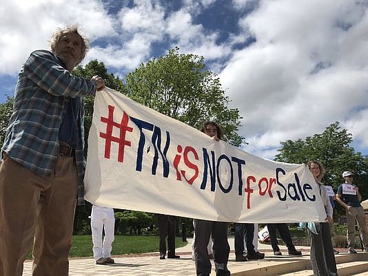 Gary McCracken, professor of ecology and evolutionary biology; Justin Baldwin, a University of Tennessee-Knoxville student and facilities maintenance worker, center; and Emily Hoffman protest the outsourcing of facilities maintenance work on the UTK campus on Monday, April 24, 2017. (Rachel Ohm/Knoxville News Sentinel)