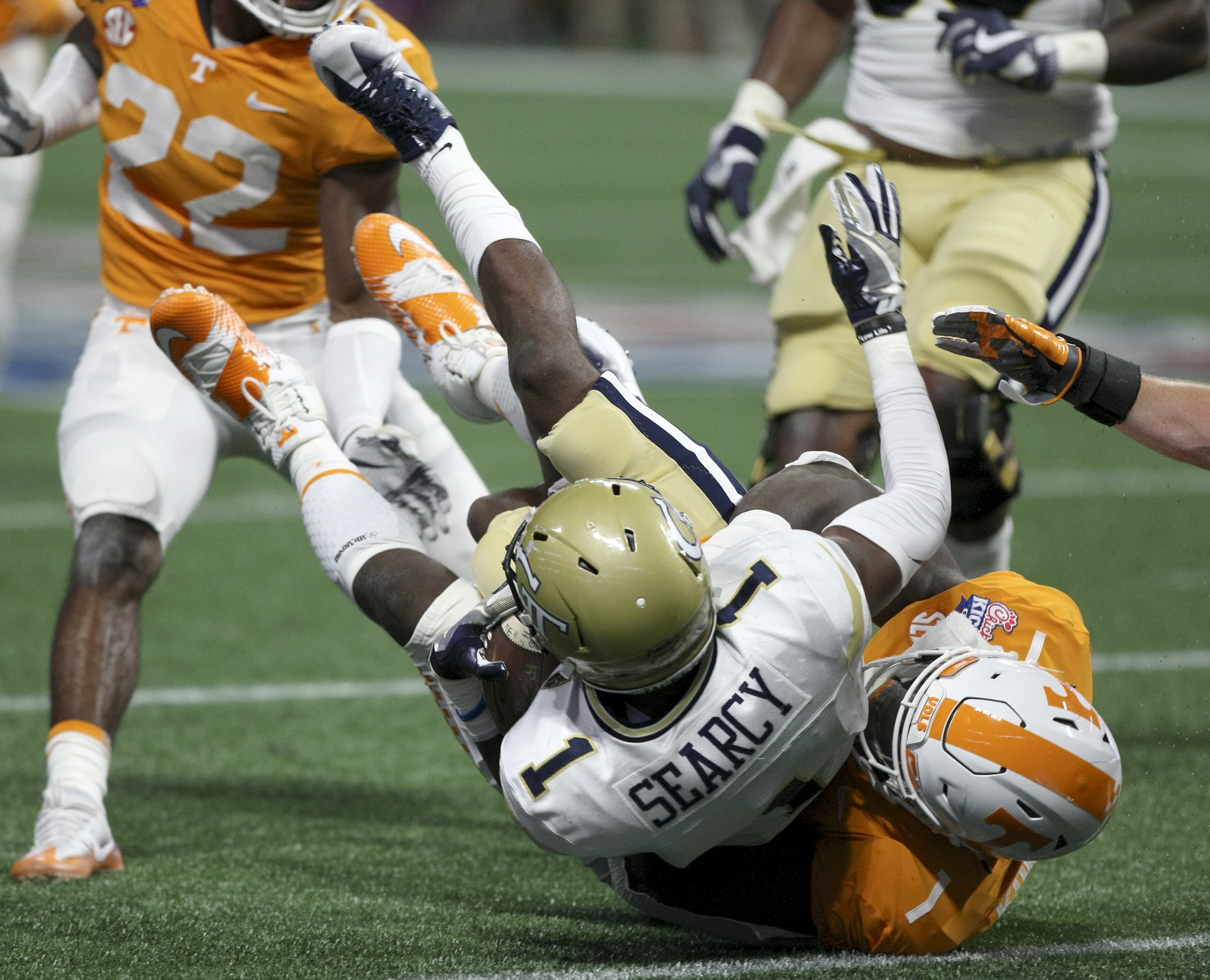 Tennessee defensive lineman Jonathan Kongbo (1) wrestles Georgia Tech running back Qua Searcy (1) to the ground during the Chick-fil-A Kickoff Game at Mercedes-Benz Stadium on Monday, Sept. 4, in Atlanta, Ga.