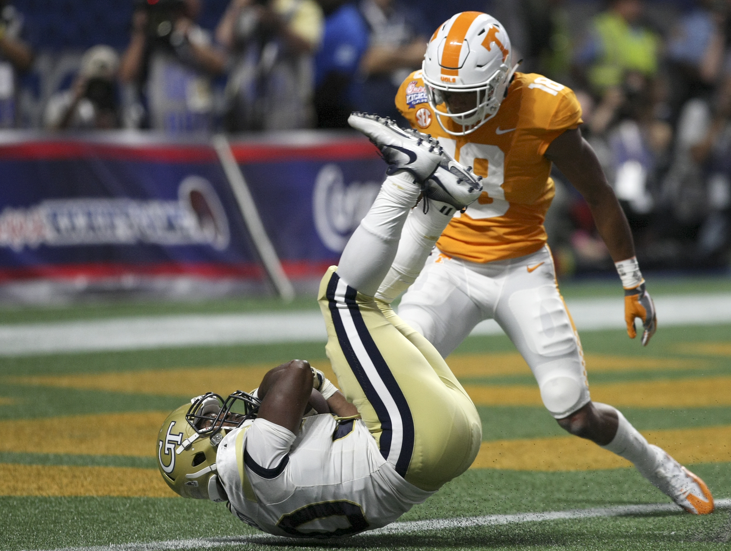 Tennessee defensive back Nigel Warrior (18) looks on as Georgia Tech running back KirVonte Benson (30) bounces just shy of the end zone during the Chick-fil-A Kickoff Game at Mercedes-Benz Stadium on Monday, Sept. 4, in Atlanta, Ga.