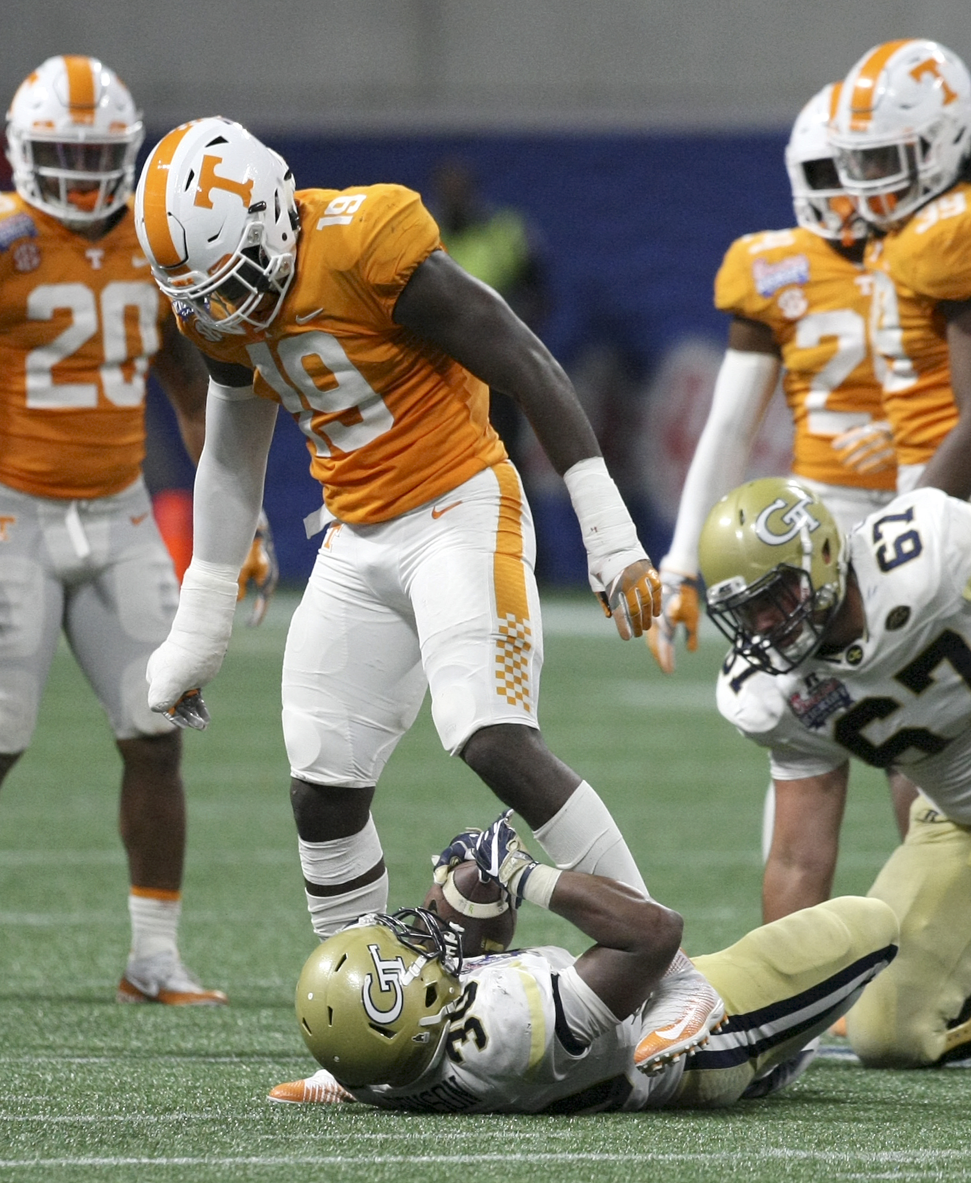 Tennessee defensive lineman Darrell Taylor (19) looks down at Georgia Tech running back KirVonte Benson (30) after hitting him during the Chick-fil-A Kickoff Game at Mercedes-Benz Stadium on Monday, Sept. 4, in Atlanta, Ga.
