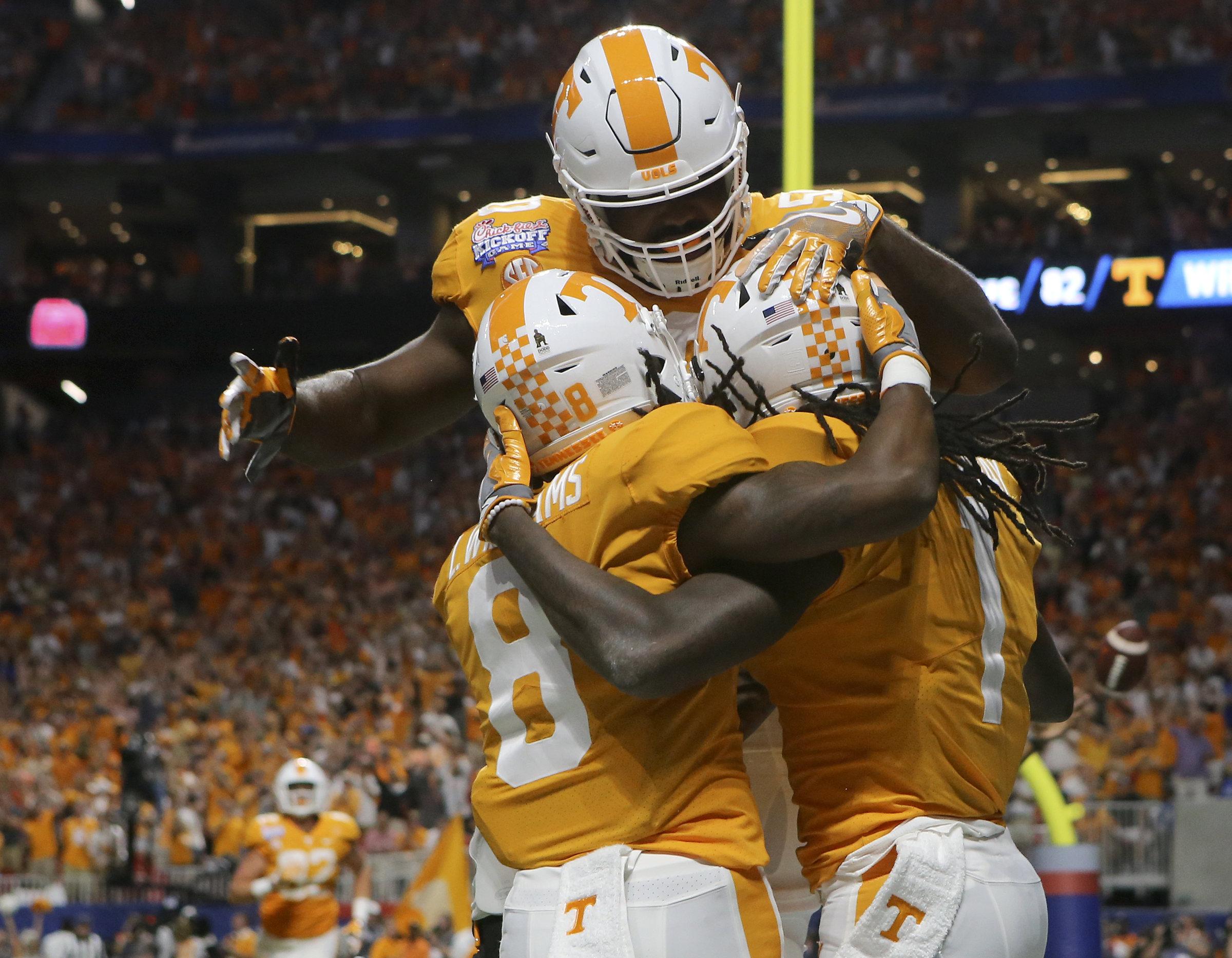 Tennessee offensive lineman Venzell Boulware (50) celebrates with wide receivers Latrell Williams (8) and Marquez Callaway (1) after Callaway's touchdown reception against Georgia Tech during the Chick-fil-A Kickoff Game at Mercedes-Benz Stadium on Monday, Sept. 4, in Atlanta, Ga.