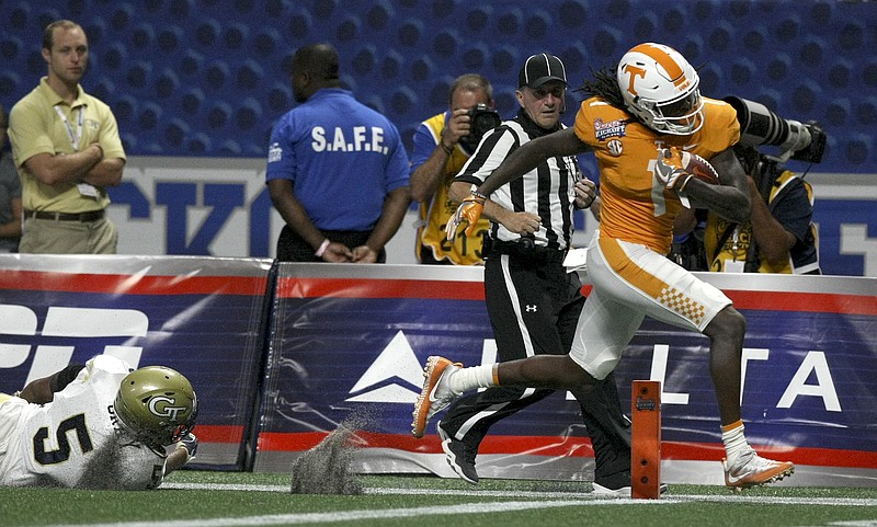 Tennessee wide receiver Marquez Callaway (1) gets past Georgia Tech defensive back A.J. Gray (5) as he races to the end zone for a touchdown during the Chick-fil-A Kickoff Game at Mercedes-Benz Stadium on Monday, Sept. 4, in Atlanta, Ga.