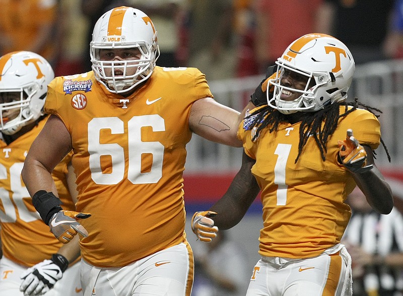 Tennessee offensive lineman Jack Jones (66) congratulates wide receiver Marquez Callaway (1) after his touchdown against Georgia Tech during the Chick-fil-A Kickoff Game at Mercedes-Benz Stadium on Monday, Sept. 4, in Atlanta, Ga.