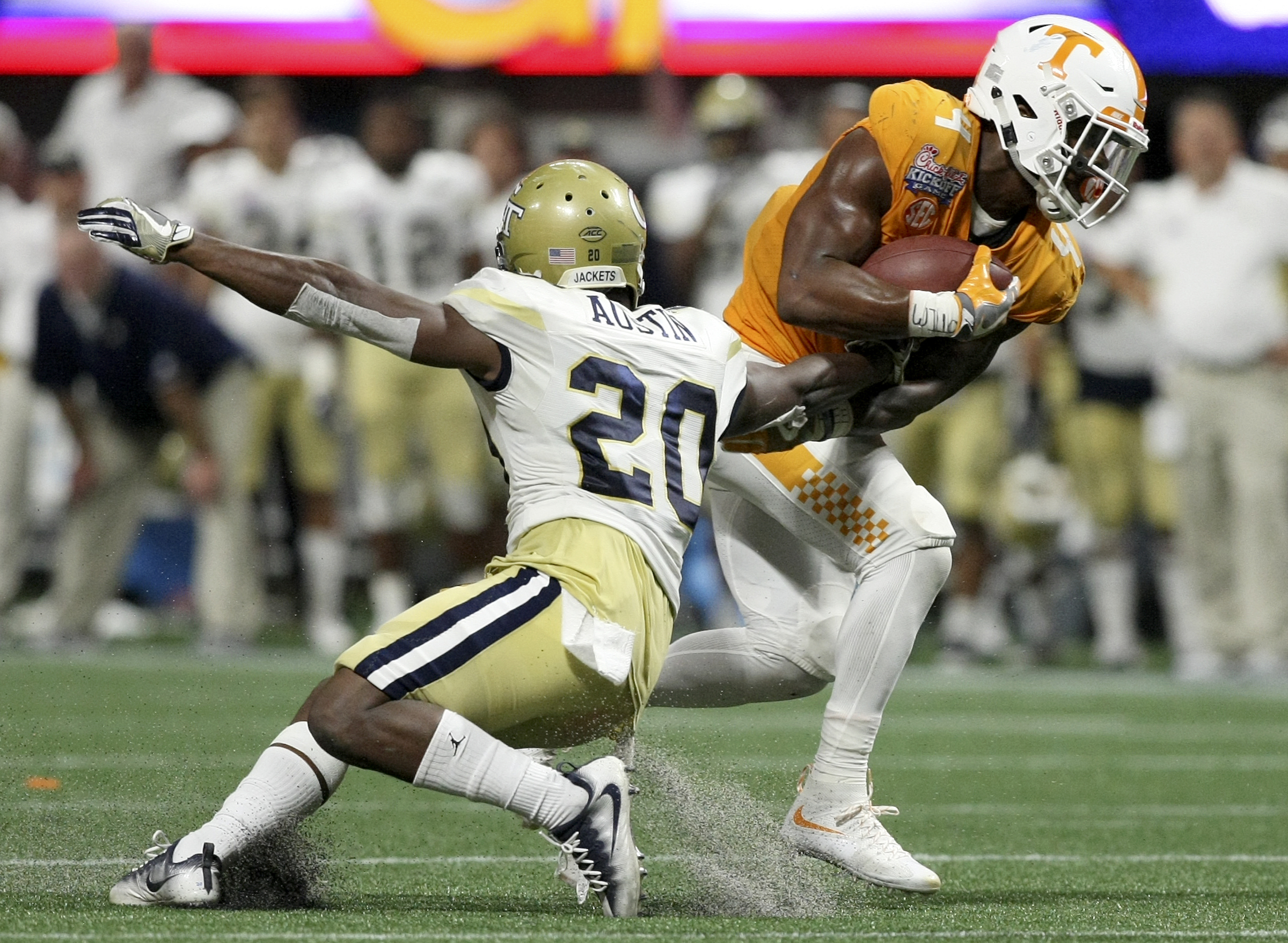 Tennessee running back John Kelly (4) gets past Georgia Tech defensive back Lawrence Austin (20) during the Chick-fil-A Kickoff Game at Mercedes-Benz Stadium on Monday, Sept. 4, in Atlanta, Ga.