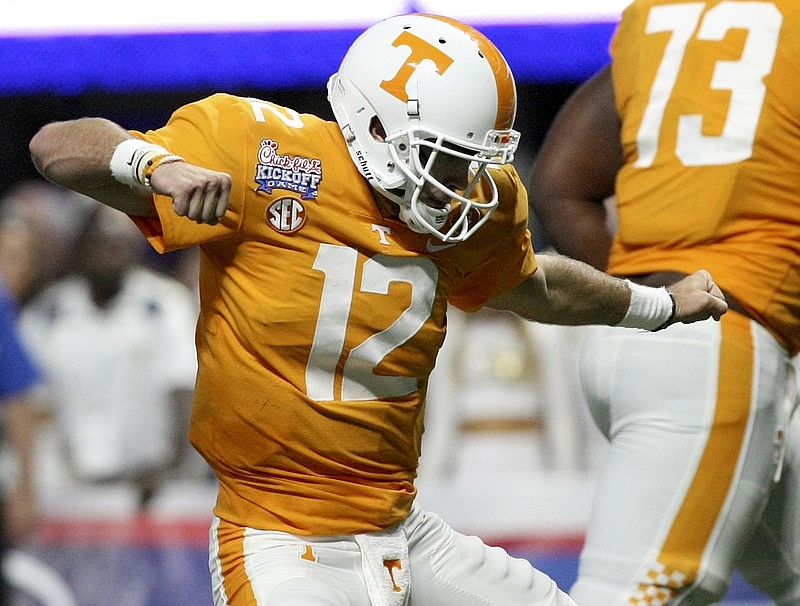 Tennessee quarterback Quinten Dormady (12) celebrates after a John Kelly touchdown against Georgia Tech during the Chick-fil-A Kickoff Game at Mercedes-Benz Stadium on Monday, Sept. 4, in Atlanta, Ga.