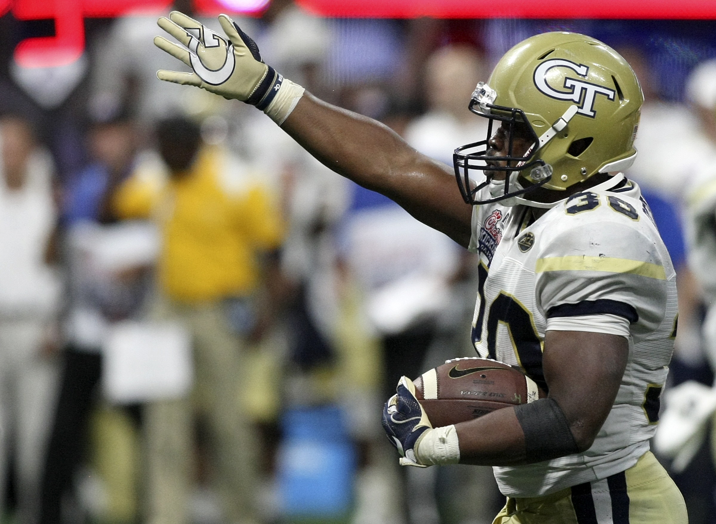 Georgia Tech running back KirVonte Benson (30) celebrates a first down against Tennessee during the Chick-fil-A Kickoff Game at Mercedes-Benz Stadium on Monday, Sept. 4, in Atlanta, Ga.