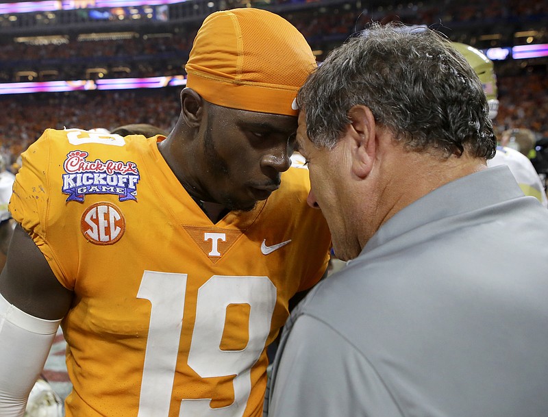 Tennessee defensive lineman Darrell Taylor (19) celebrates with defensive line coach Brady Hoke after their double overtime victory over Georgia Tech during the Chick-fil-A Kickoff Game at Mercedes-Benz Stadium on Monday, Sept. 4, in Atlanta, Ga.