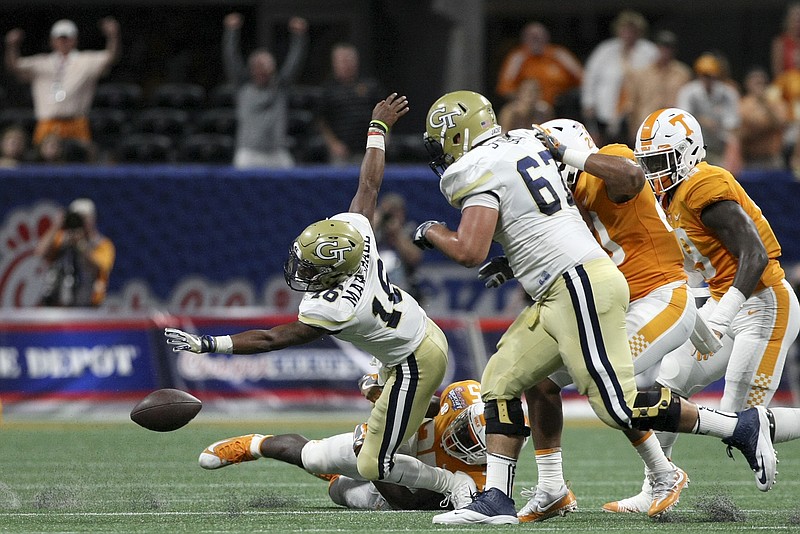 Tennessee linebacker Daniel Bituli (35) forces Georgia Tech quarterback TaQuon Marshall (16) to fumble the ball during the Chick-fil-A Kickoff Game at Mercedes-Benz Stadium on Monday, Sept. 4, in Atlanta, Ga.