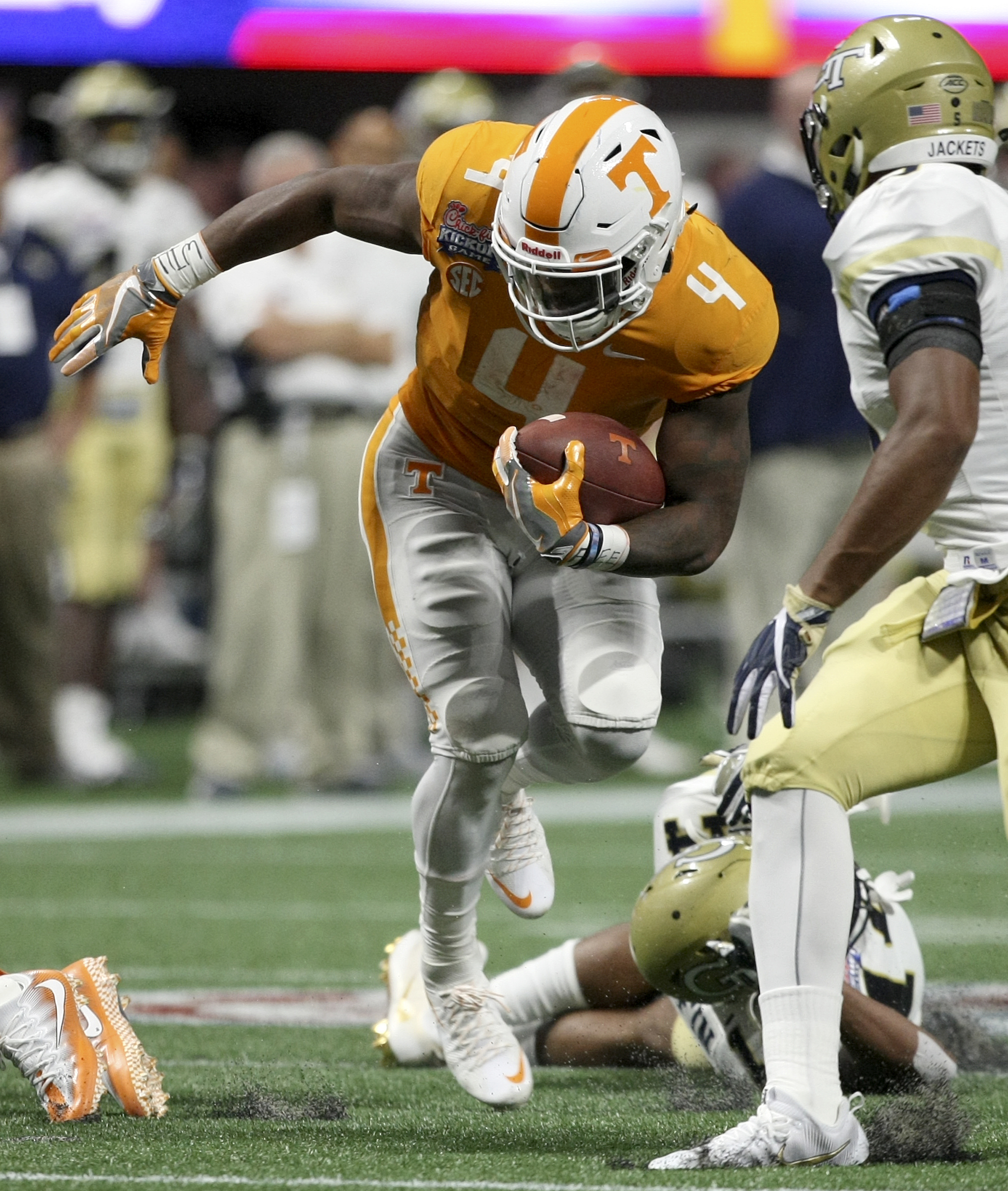Tennessee running back John Kelly (4) rushes for a 26-yard gain against Georgia Tech during the Chick-fil-A Kickoff Game at Mercedes-Benz Stadium on Monday, Sept. 4, in Atlanta, Ga.